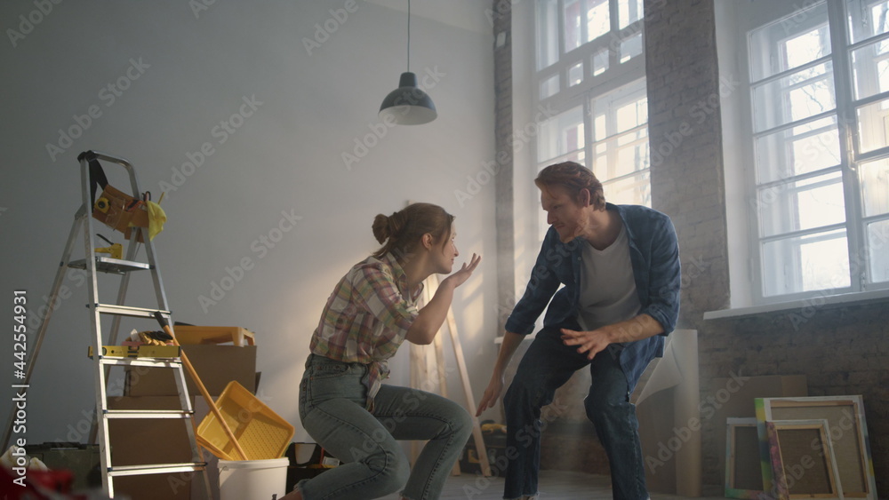 Married woman and man relaxing in new apartment. House renovation concept.