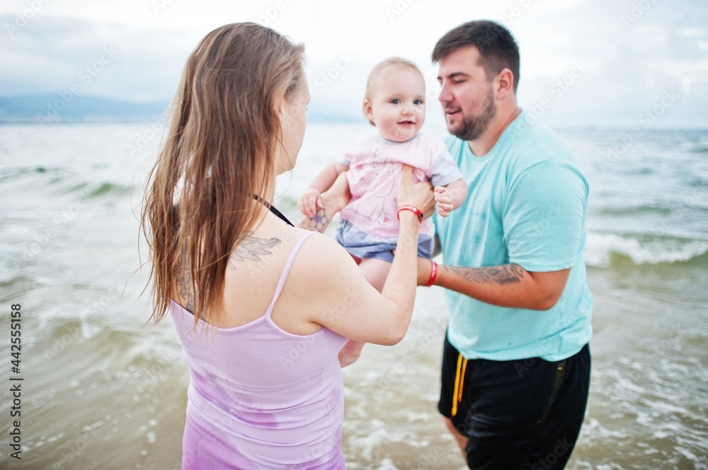 Summer vacations. Parents and people outdoor activity with children. Happy family holidays. Father, pregnant mother, baby daughter on sea sand beach. Summer vacations. Parents and people outdoor activity with children. Happy family holidays. Father, pregnant mother, baby daughter on sea sand beach.