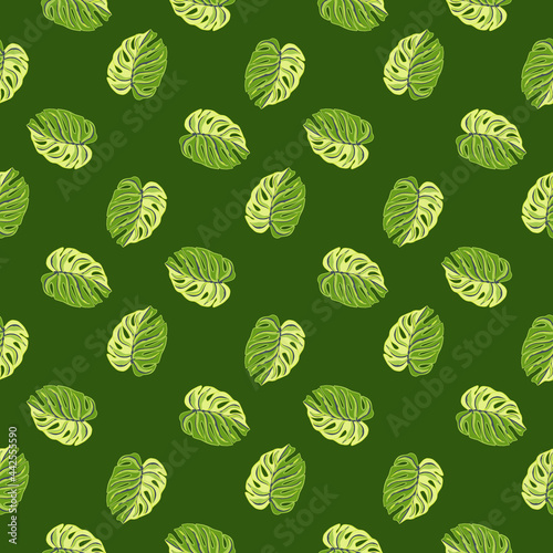 Hand drawn tropical seamless pattern with doodle ornamental monstera shapes print. Green colors.
