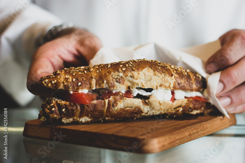 Sandwiches with fried meat, tomatoes, mayo, vegetables and boiled eggs photo
