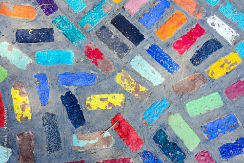 Top view on pieces of multicolored ceramic tiles decorated in garden. Old pavement of tiles textured. Street mosaic cobblestone sidewalk. Abstract,background and pattern of ceramic tile on the floor.