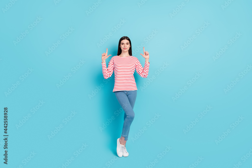 Full length body size view of attractive confident girl recommending up copy space offer isolated over bright blue color background Full length body size view of attractive confident girl recommending up copy space offer isolated over bright blue color background