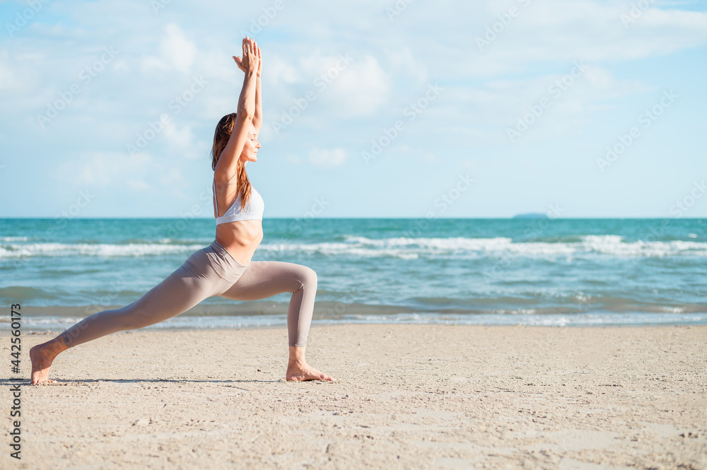 Caucasian woman practicing yoga at seashore Caucasian woman practicing yoga at seashore