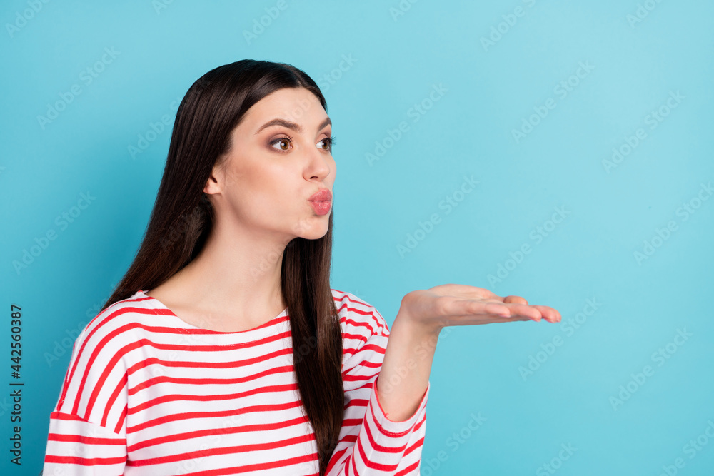 Profile side view portrait of attractive amorous girl sending air kiss copy space isolated over bright blue color background Profile side view portrait of attractive amorous girl sending air kiss copy space isolated over bright blue color background