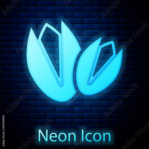 Glowing neon Pistachio nuts icon isolated on brick wall background. Vector