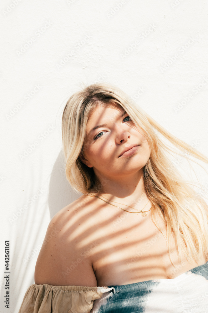 attractive plus size young woman outdoors portrait with tropical shadows attractive plus size young woman outdoors portrait with tropical shadows