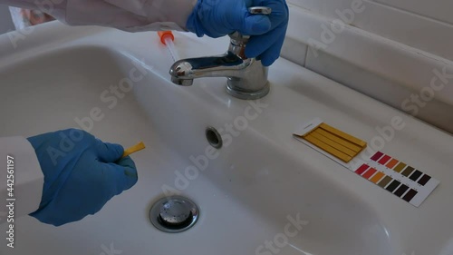 measurement of the pH of the drinking water with litmus paper in the bathroom