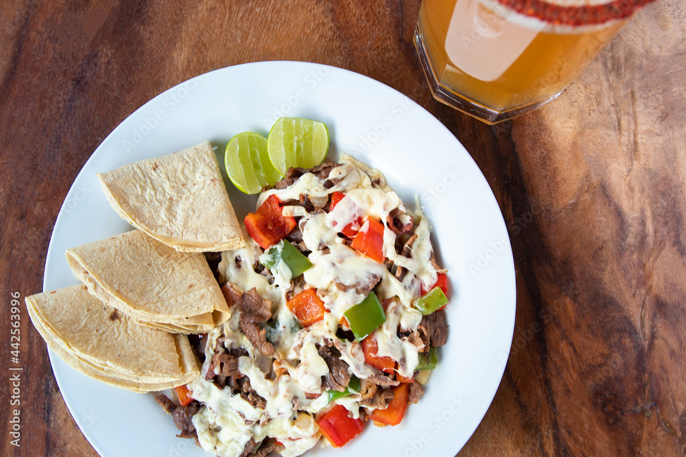 Mexican wire with corn tortillas. Traditional Mexican food. Mexican food on wooden background. Traditional Mexican food concept. Alambre tacos.