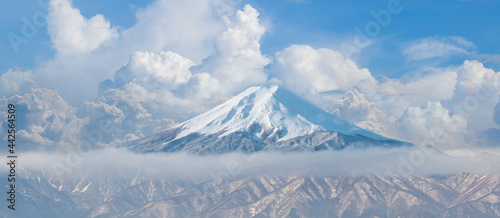 Beautiful Fuji mountain with snow cover on the top with could. Mount fuji from lake kawaguchi side. Panorama view of snow mountains and clouds. photo