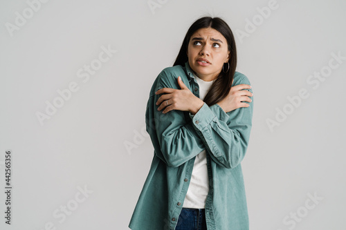 Φωτογραφία Young confused woman trembling and feeling cold