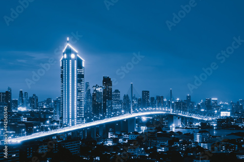 Photography Aerial view of Rama 9 bridge and Kasikorn Building, with skyscraper high rise buildings in urban city, Downtown Bangkok skyline, Thailand at night