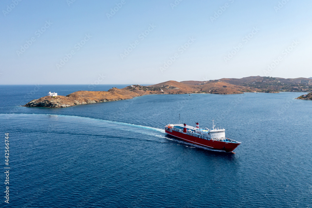 Kea, Tzia island, Cyclades, Greece. Aerial drone view of a ferry approaching Korissia port.