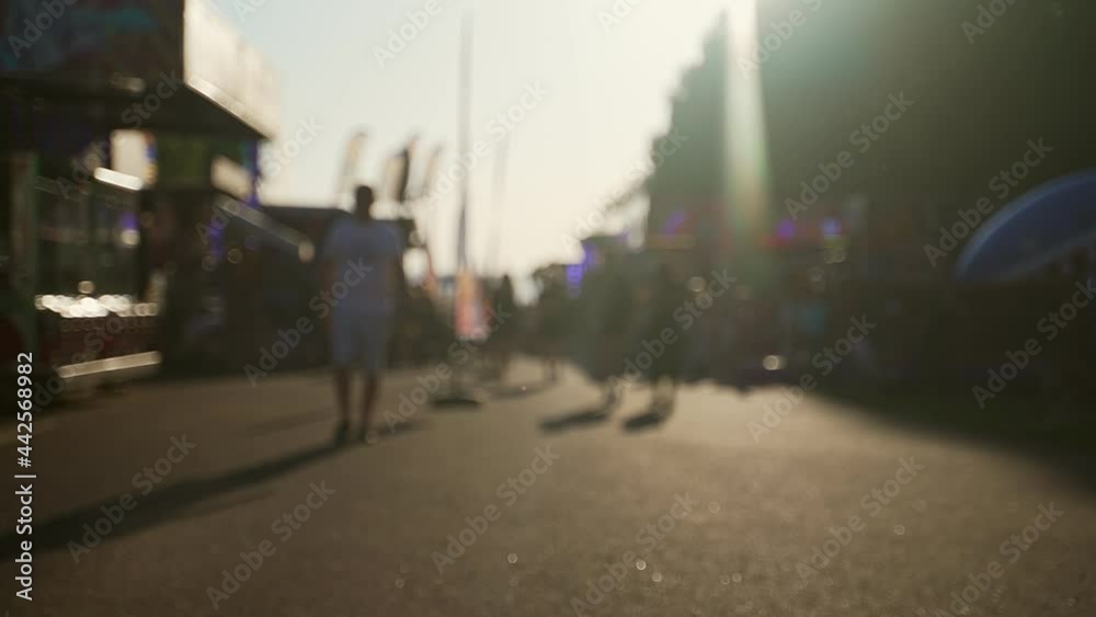 People walk down the street in summer. Blurred shot. People walk down the street in summer. Blurred shot.