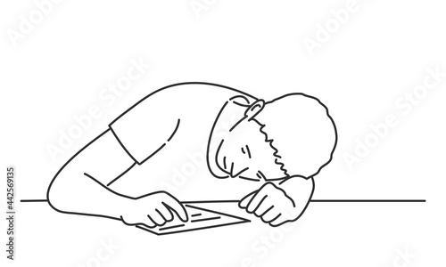 Bored man, tired and exhausted student sits with his head on the table.