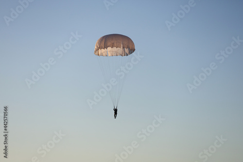 Paratrooper is flying in the sky.