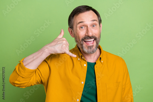 Foto Photo of cheerful mature happy positive man make call me sign smile isolated on