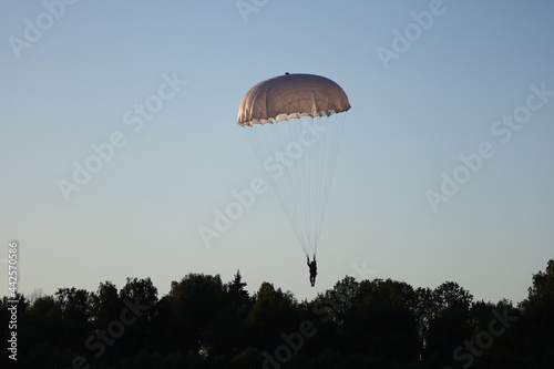 Paratrooper is flying in the sky.