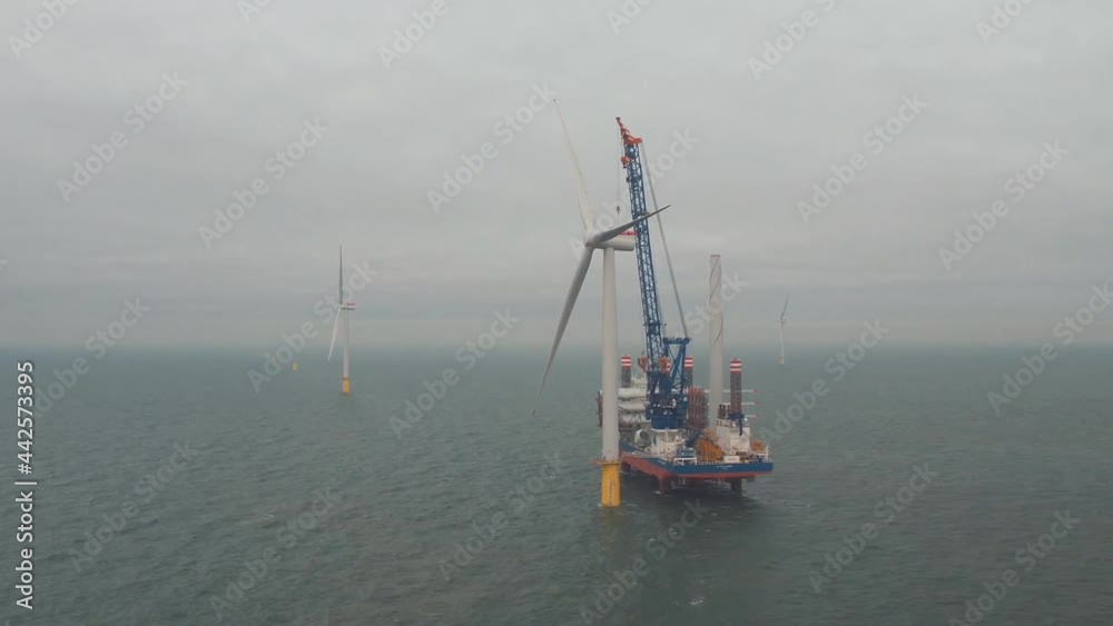 Balmedy, Aberdeenshire, Scotland, UK. Aerial view of a special vessel for the installation of wind farms, installing a wind turbine off the coast of Aberdeen. Balmedy, Aberdeenshire, Scotland, UK. Aerial view of a special vessel for the installation of wind farms, installing a wind turbine off the coast of Aberdeen.