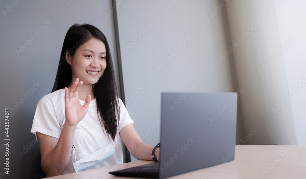 Happy Asian woman study online learning on video call zoom with laptop at home. New normal studying through online e-learning system. Happy Asian woman study online learning on video call zoom with laptop at home. New normal studying through online e-learning system.