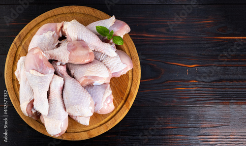 raw chicken legs, chicken drumsticks on a wooden background with spices. Copy space top view