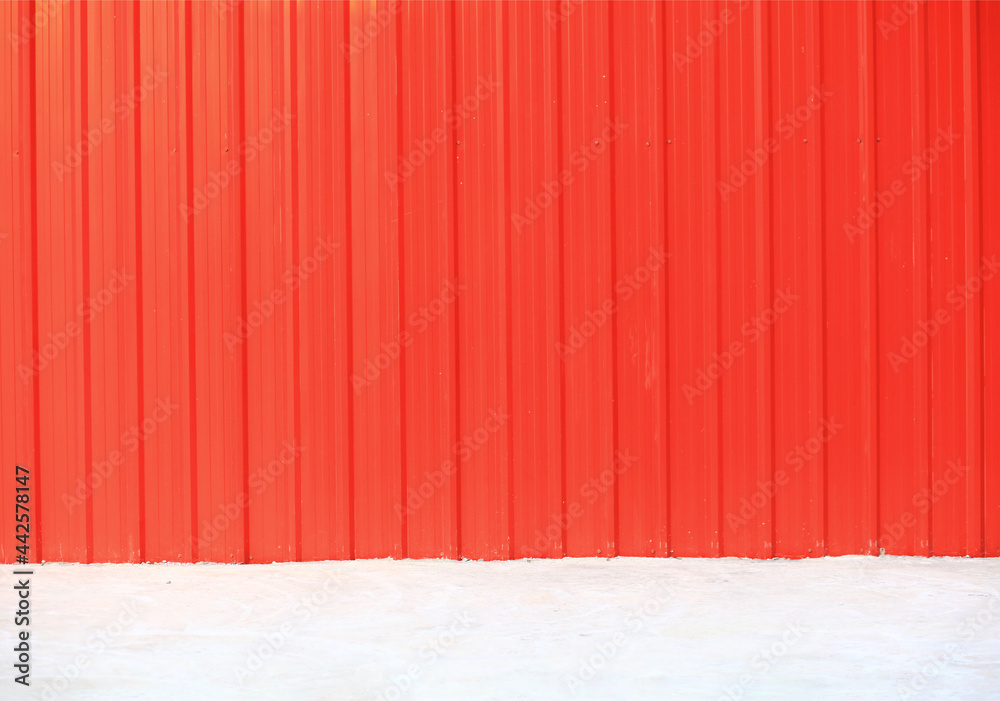 Orange pattern background of metal sheet, orange metal wall vertical on concrete floor Orange pattern background of metal sheet, orange metal wall vertical on concrete floor
