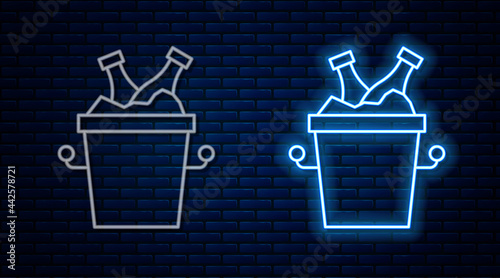 Glowing neon line Beer bottles in ice bucket icon isolated on brick wall background. Vector