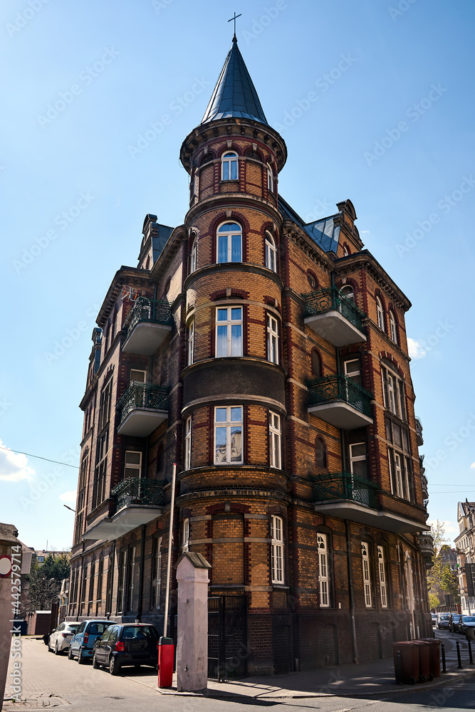 Naklejka premium a historic tenement house with a round tower in the city of Poznan 
