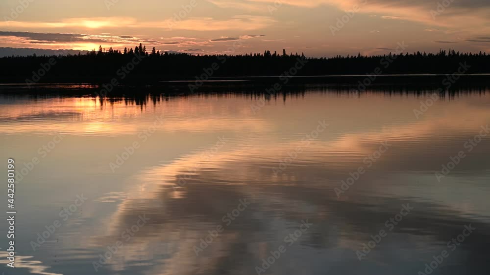 Sunset on a calm lake with rich colors. At 5 seconds a large fish jumps out of the water. Rainbow trout.
Sunset on a calm lake with rich colors. At 5 seconds a large fish jumps out of the water. Rainbow trout.