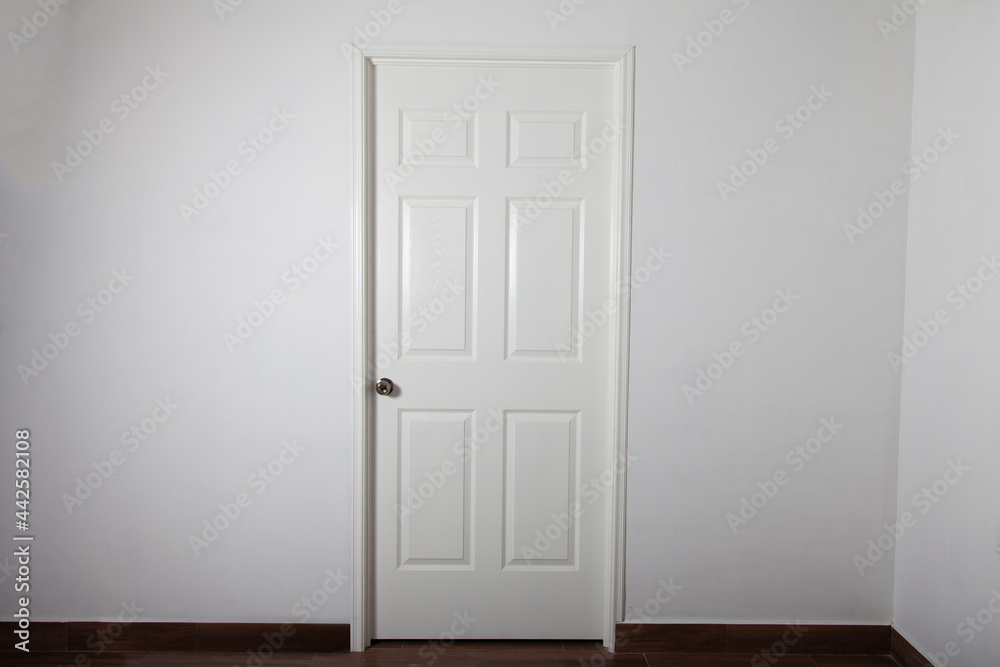 closed white door on gray wall closed white door on gray wall