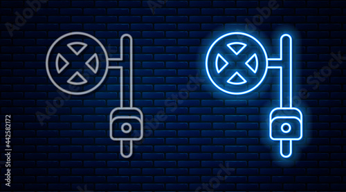 Glowing neon line Stop sign with camera icon isolated on brick wall background. Traffic regulatory warning stop symbol. Vector