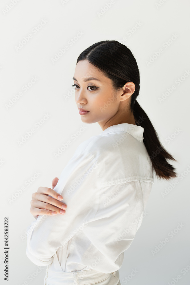 Japanese woman in white clothes looking away isolated on grey Japanese woman in white clothes looking away isolated on grey