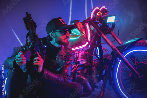 A special force agent with a rifle is hiding behind a futuristic motorbike and shooting. Cyberpunk concept.