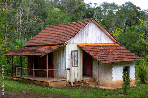 Rustic old abandoned wooden house in the forest in selective focus.
