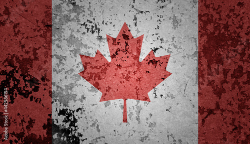 Flag of Canada painted on the old grunge rustic iron surface. Abstract paint of Canadian national flag on the iron surface