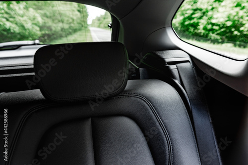 Back black leather passenger seats in modern car. © Natallia