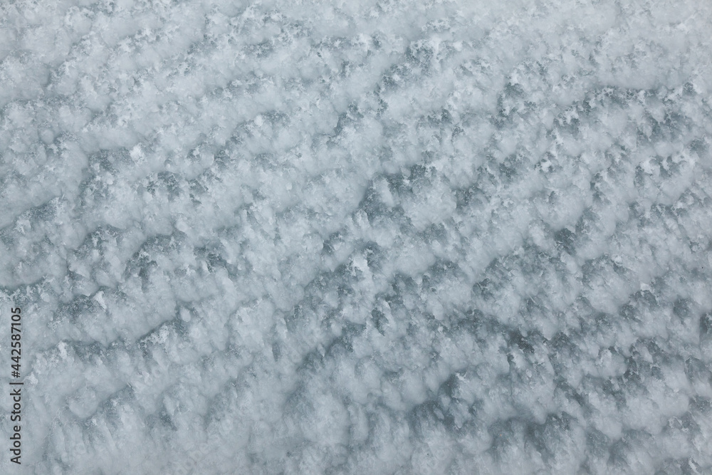 Frozen, uneven, icy texture, close-up. Rough ice.