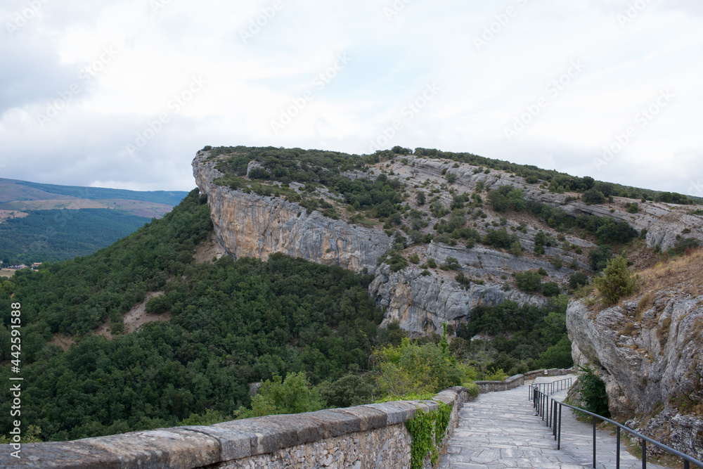 Natural rocks of the National Monument Ojo Guarena and walking path to access to the caves. Merindades, Burgos, Spain, Europe