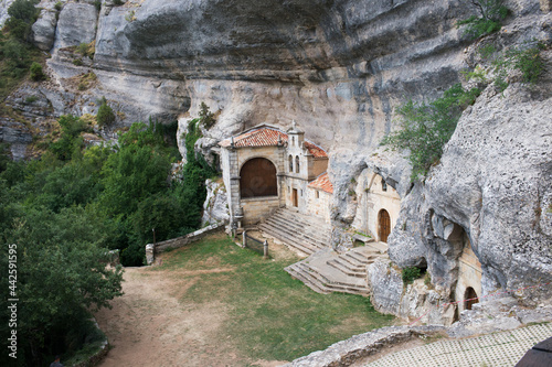 Access to National Monument Ojo Guarena. Caves and church in the rocks. Merindades, Burgos, Spain photo