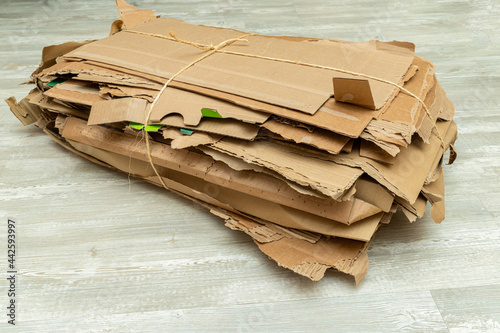 Many torn cardboard boxes assembled in a bundle, stack for recycling