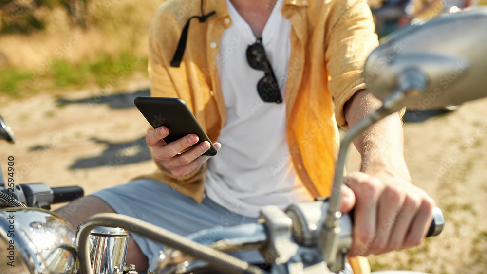 Smartphone in hands of young caucasian man on scooter Smartphone in hands of young caucasian man on scooter