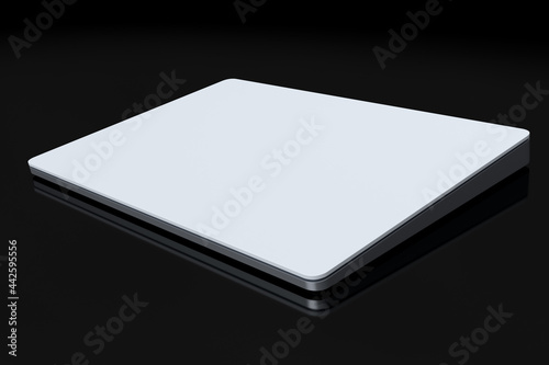 Silver computer trackpad or wireless touch pad isolated on black background photo