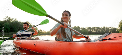 Φωτογραφία Happy young couple of friends having fun on kayak on a late summer afternoon