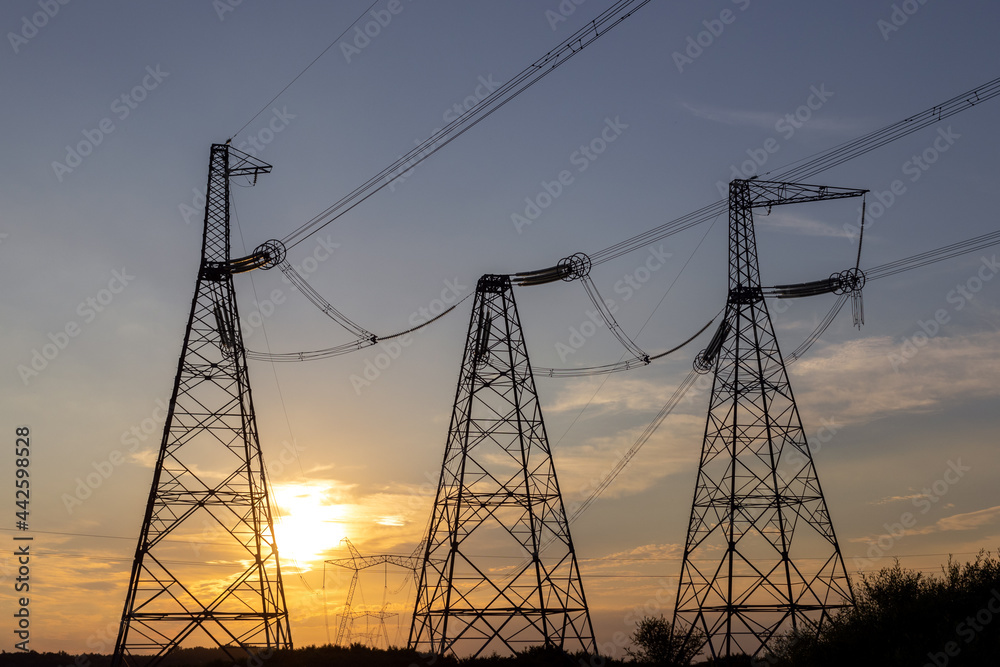 Electric poles on which high-voltage electric wires are laid. Electricity supply, electricity tariffs, ecology.