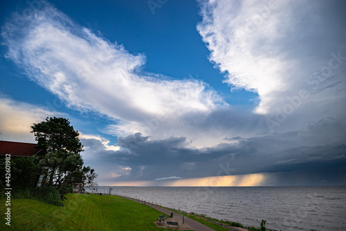 Anvils of thunderstorms over lake IJsselmeer, Netherlands at sunset photo
