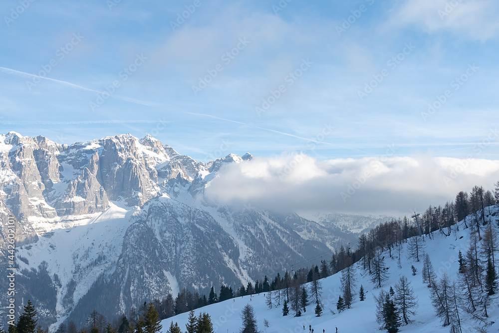 View of the snow-capped mountain peaks of the Dolomites against the sky. Concept background, landscape