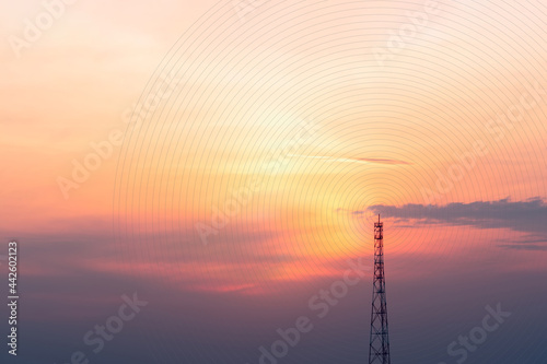 A view of the signal tower at sunset in vibrant orange pinks and violet colors