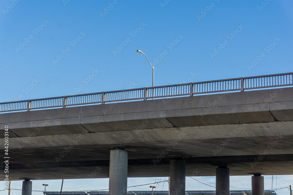 View from below of a flyover road suspended on concrete pillars View from below of a flyover road suspended on concrete pillars