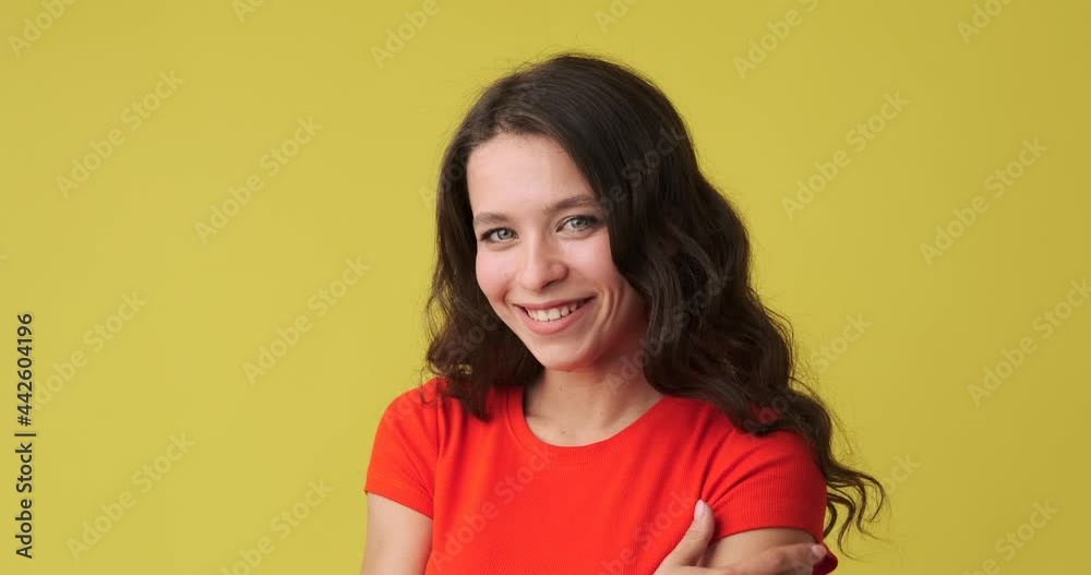 Beautiful woman smiling over yellow background Beautiful woman smiling over yellow background