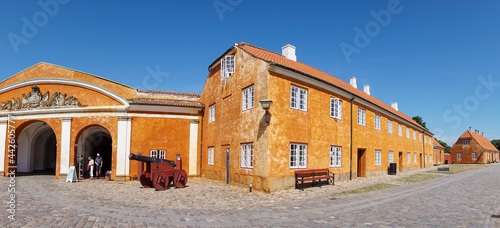the barrack buildings at Kronborg Castle with an old cannon in the foreground photo