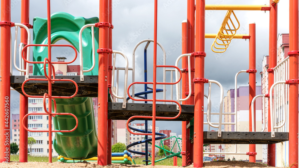 coloured attractions on local playground against buildings coloured attractions on local playground against buildings